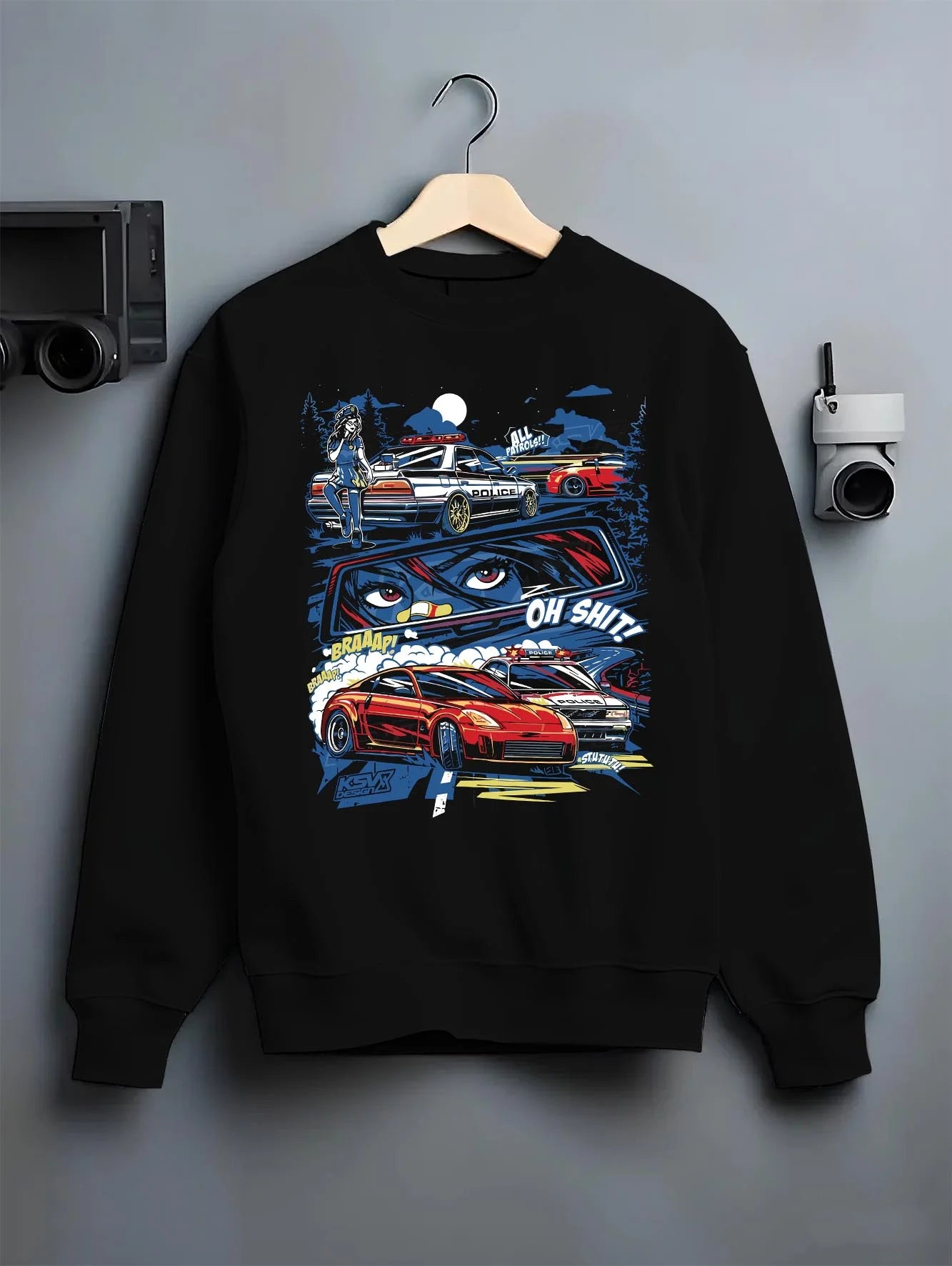 Black crewneck sweatshirt on a hanger against a grey wall, featuring STI street racing performance motorsport automotive police.