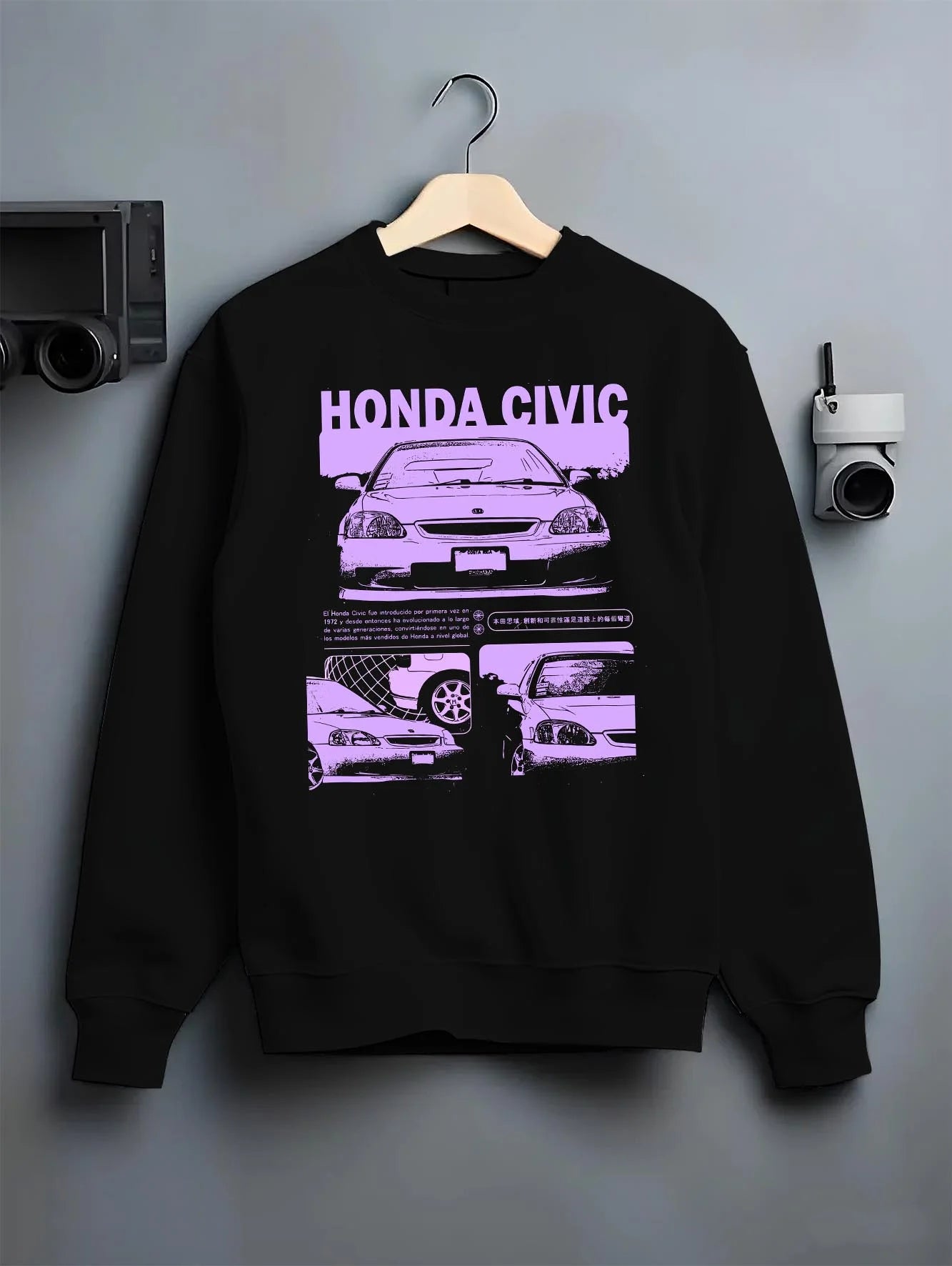 Black crewneck sweatshirt on a hanger against a grey wall, featuring Honda Prelude rs race motorsport street retro vintage graphic.