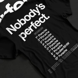 Black T-shirt laid flat with natural fabric folds, featuring Porsche rs racing le mans motorsport street performance graphic.