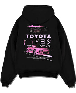 Black pullover hoodie laid flat on a white background, featuring Toyota Supra racing drift jdm japanese tuner street retro graphic.