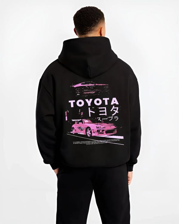 Black hoodie worn by a male model, back view, featuring Toyota Supra racing drift jdm japanese tuner street retro graphic.