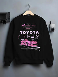 Black crewneck sweatshirt on a hanger against a grey wall, featuring Toyota Supra racing drift jdm japanese tuner street graphic.