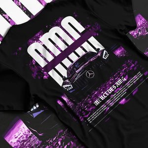 Black T-shirt laid flat with natural fabric folds, featuring Mercedes-Benz AMG racing street enthusiast performance graphic.