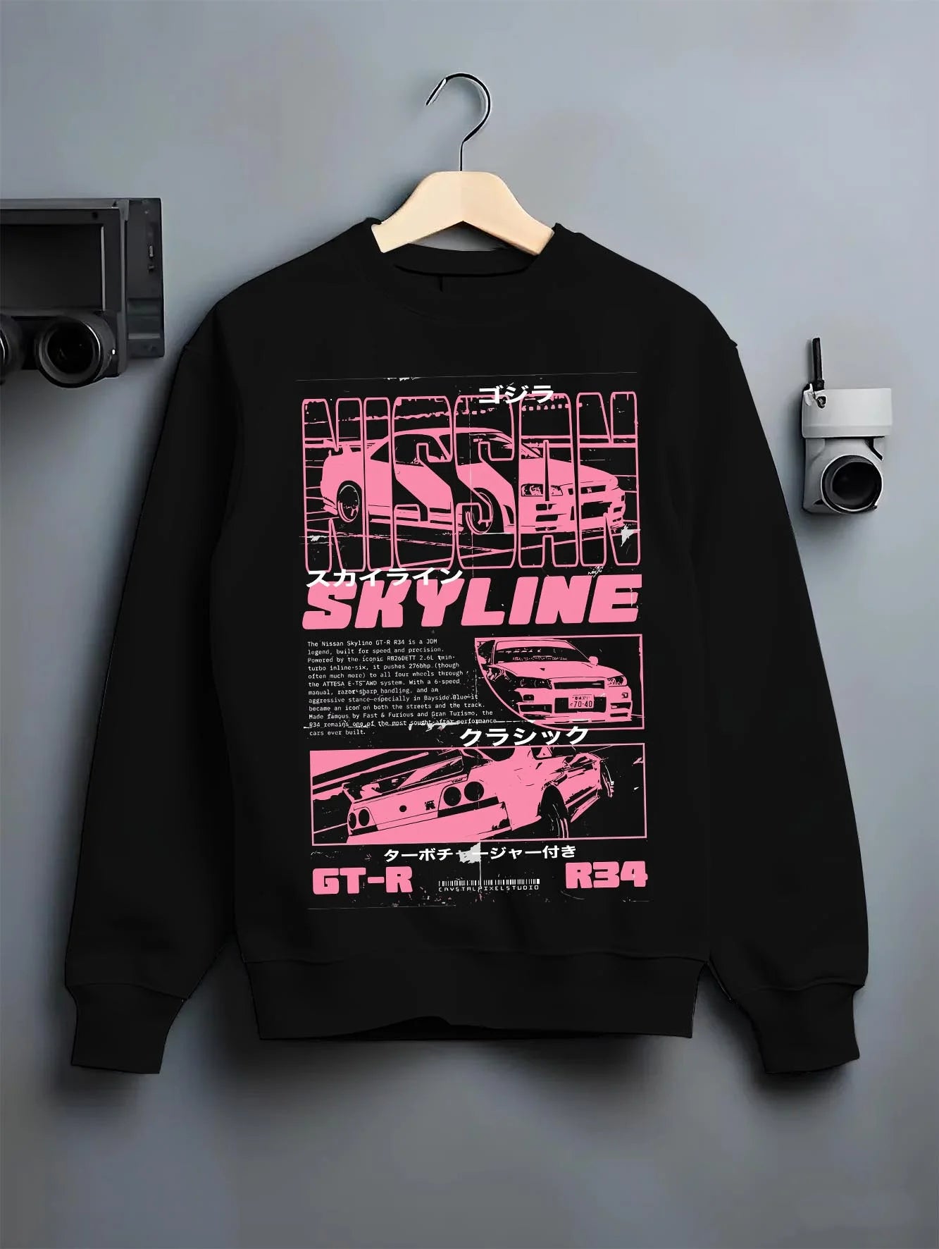 Black crewneck sweatshirt on a hanger against a grey wall, featuring Nissan SKYLINE r34 turbo racing drift jdm japanese graphic.