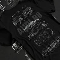 Black T-shirt laid flat with natural fabric folds, featuring Audi R8 v10 racing german street performance motorsport graphic.