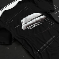 Black T-shirt laid flat with natural fabric folds, featuring Audi R8 turbo v10 racing german street performance graphic.