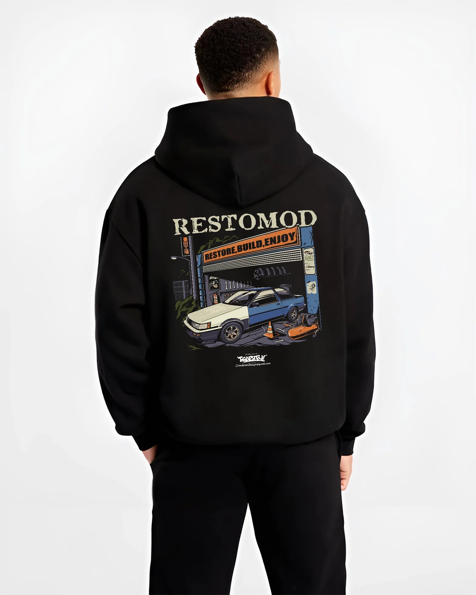Black hoodie worn by a male model, back view, featuring Toyota AE86 drift jdm tuner street racing performance graphic.