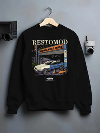 Black crewneck sweatshirt on a hanger against a grey wall, featuring Toyota AE86 drift jdm tuner street racing performance graphic.
