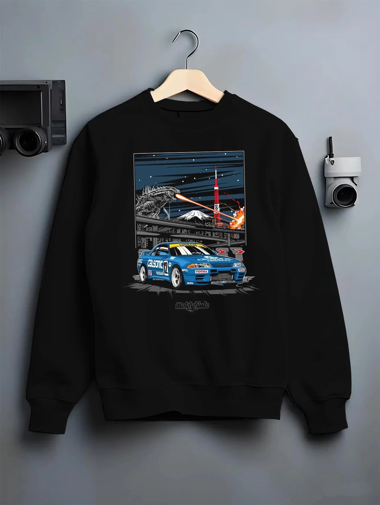Black crewneck sweatshirt on a hanger against a grey wall, featuring rs jdm japanese tuner street retro enthusiast racing graphic.