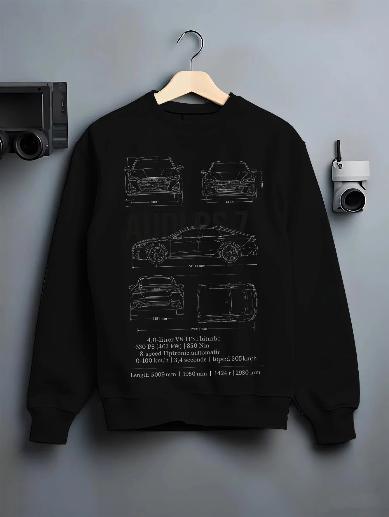 Black crewneck sweatshirt on a hanger against a grey wall, featuring Audi RS7 rs turbo racing german street performance graphic.