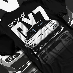 Black T-shirt laid flat with natural fabric folds, featuring Mazda RX-7 rx7 drift japanese tuner stance street graphic.