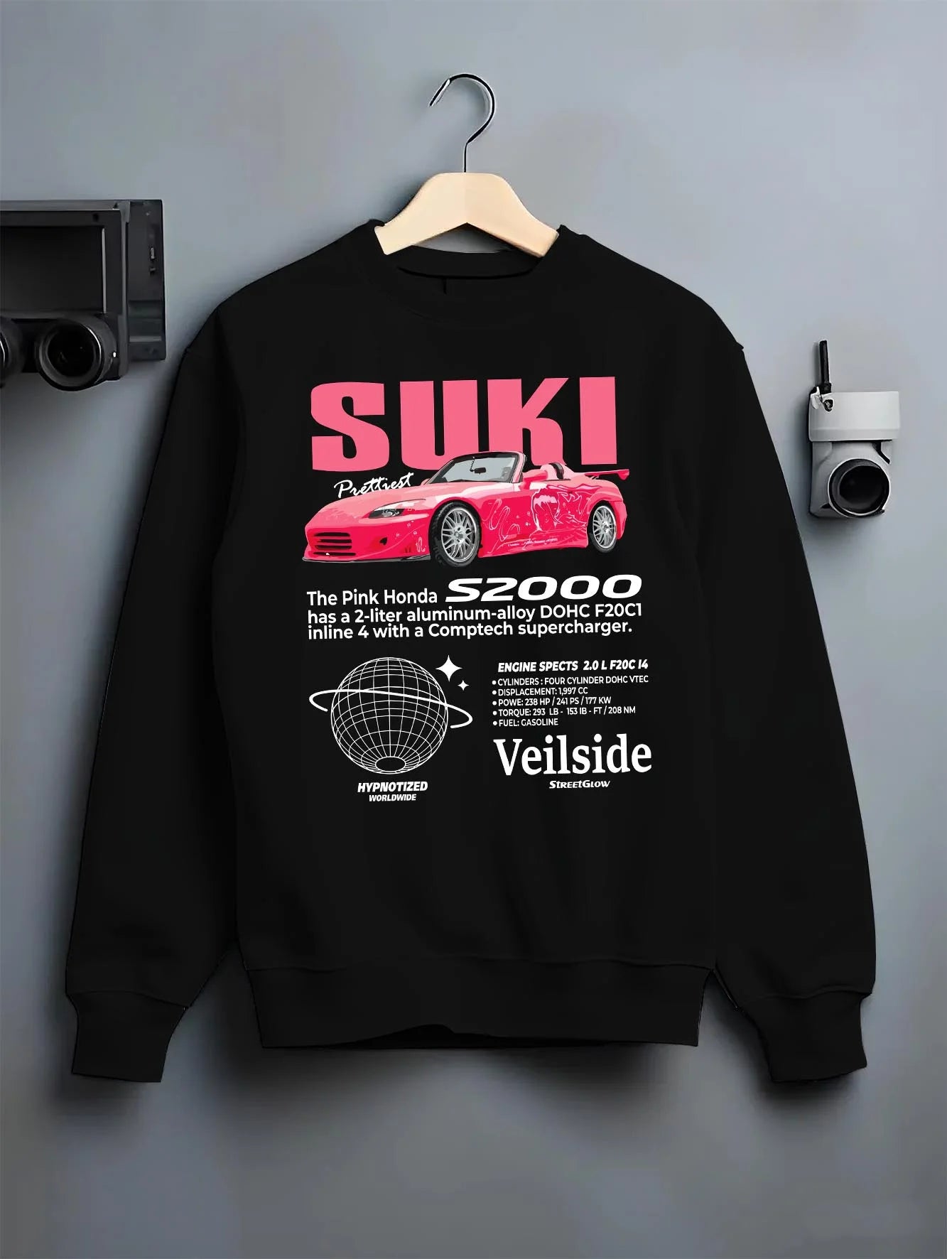 Black crewneck sweatshirt on a hanger against a grey wall, featuring Honda S2000 drift jdm japanese tuner street racing graphic.