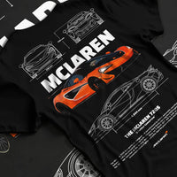 Black T-shirt laid flat with natural fabric folds, featuring McLaren SENNA rs racing motorsport speed street performance graphic.