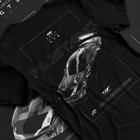 Black T-shirt laid flat with natural fabric folds, featuring shelby turbo turbocharged racing american muscle street graphic.