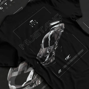 Black T-shirt laid flat with natural fabric folds, featuring shelby turbo turbocharged racing american muscle street graphic.