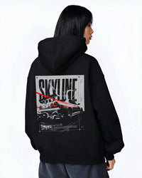 Black hoodie worn by a female model, back view, featuring Nissan Skyline R34 r34 skyline turbo turbocharged racing jdm graphic.