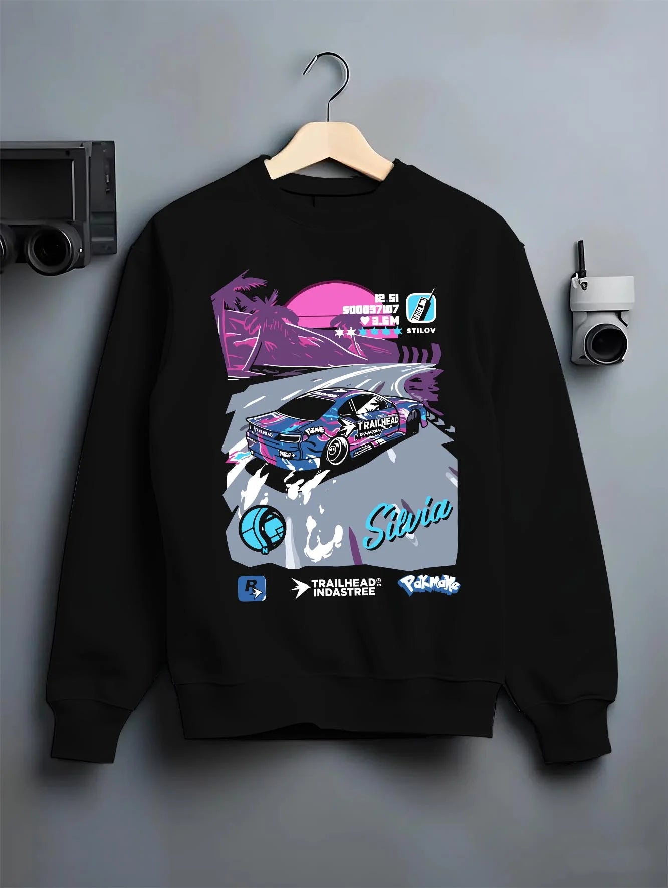 Black crewneck sweatshirt on a hanger against a grey wall, featuring SILVIA racing drift jdm japanese street retro graphic.