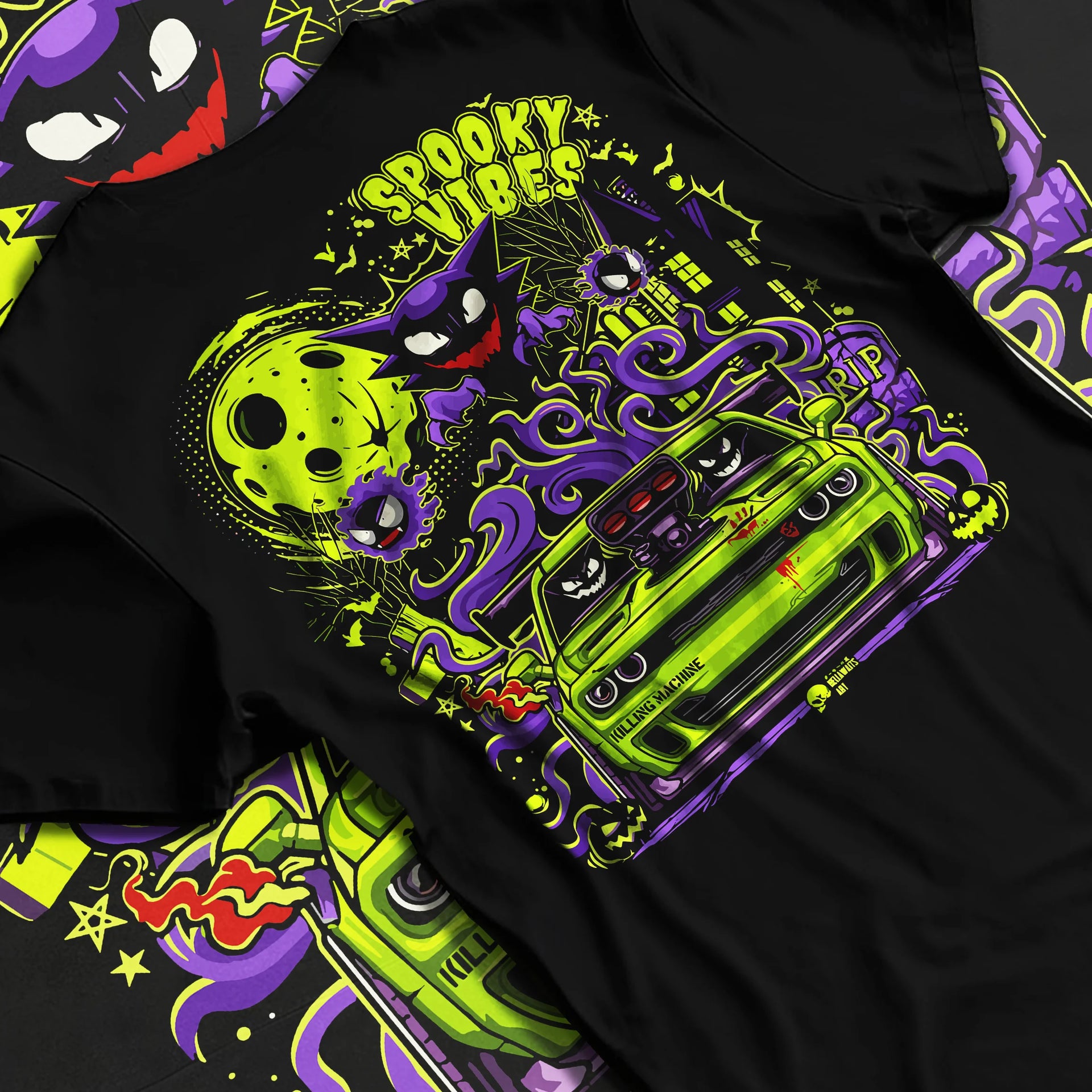 Black T-shirt laid flat with natural fabric folds, featuring jdm street racing performance motorsport automotive enthusiast graphic.