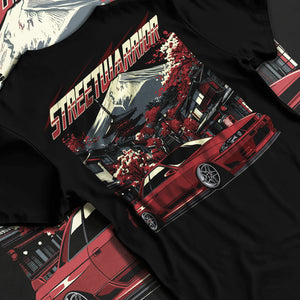 Black T-shirt laid flat with natural fabric folds, featuring SKYLINE r32 drift jdm street retro racing performance graphic.