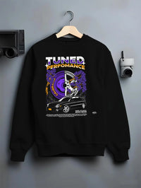 Black crewneck sweatshirt on a hanger against a grey wall, featuring Subaru WRX rally legend racing street performance graphic.