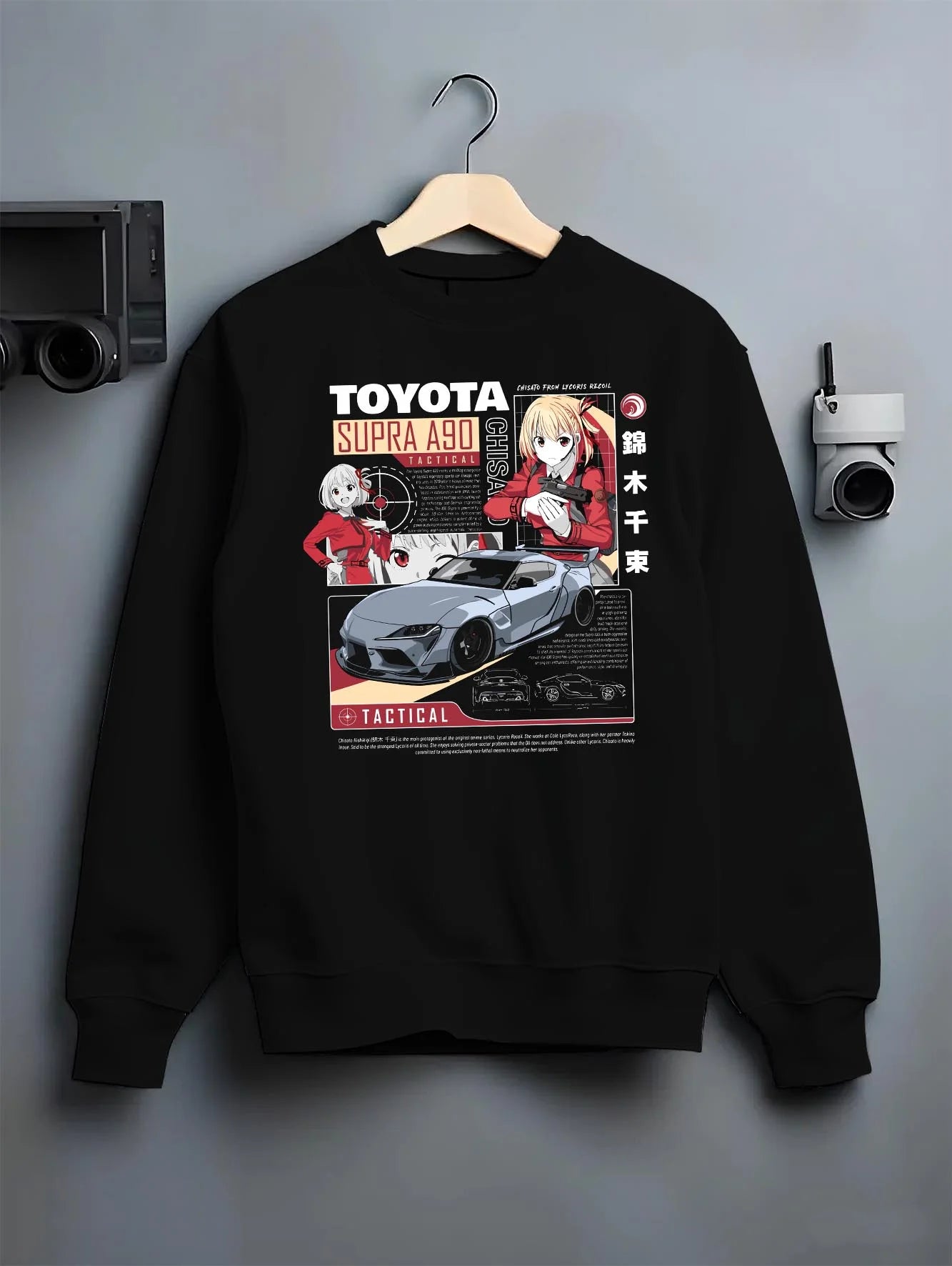 Black crewneck sweatshirt on a hanger against a grey wall, featuring Toyota Supra A90 supra turbo racing jdm street graphic.