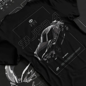Black T-shirt laid flat with natural fabric folds, featuring Toyota Supra turbo turbocharged racing drift jdm tuner graphic.
