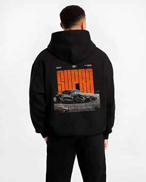 Black hoodie worn by a male model, back view, featuring Toyota Supra turbo racing drift jdm japanese tuner street graphic.