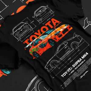 Black T-shirt laid flat with natural fabric folds, featuring Toyota Supra MK4 supra turbo turbocharged racing drift jdm graphic.