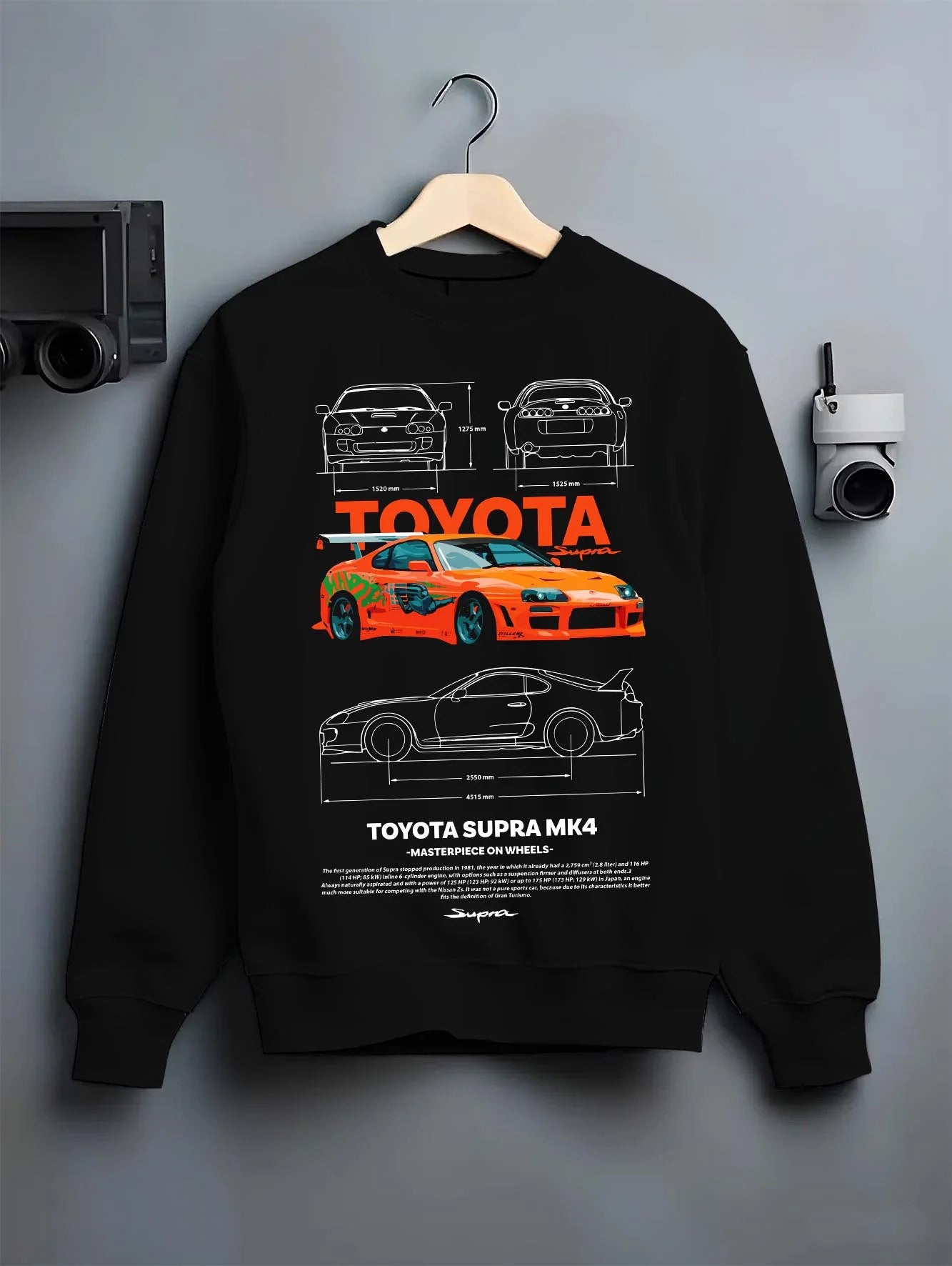 Black crewneck sweatshirt on a hanger against a grey wall, featuring Toyota Supra MK4 supra turbo turbocharged racing drift graphic.