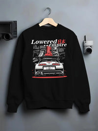Black crewneck sweatshirt on a hanger against a grey wall, featuring Toyota Supra turbo drift jdm lowered power racing graphic.