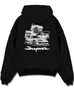 Black pullover hoodie laid flat on a white background, featuring Toyota Supra turbo turbocharged jdm street classic racing graphic.