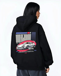 Black hoodie worn by a female model, back view, featuring Toyota Supra drift tokyo underground tokyo drift racing street graphic.