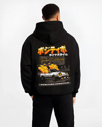 Black hoodie worn by a male model, back view, featuring Toyota AE86 drift jdm racing street performance motorsport graphic.