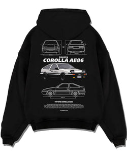 Black pullover hoodie laid flat on a white background, featuring Toyota AE86 drift legend racing street performance graphic.