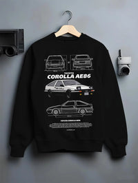 Black crewneck sweatshirt on a hanger against a grey wall, featuring Toyota AE86 drift legend racing street performance graphic.