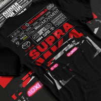 Black T-shirt laid flat with natural fabric folds, featuring Toyota MR2 turbo racing drift jdm tuner street classic graphic.