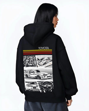Black hoodie worn by a female model, back view, featuring Toyota Supra rs racing jdm tuner street vintage enthusiast graphic.