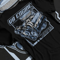 Black T-shirt laid flat with natural fabric folds, featuring rs v8 muscle street racing performance motorsport automotive graphic.
