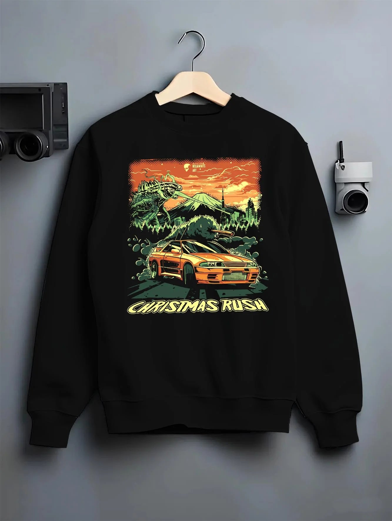 Black crewneck sweatshirt on a hanger against a grey wall, featuring SKYLINE r32 drift jdm street monster racing graphic.