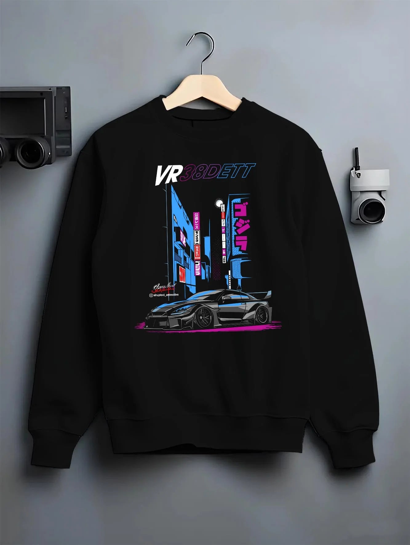 Black crewneck sweatshirt on a hanger against a grey wall, featuring Nissan 370Z turbo turbocharged racing drift jdm graphic.