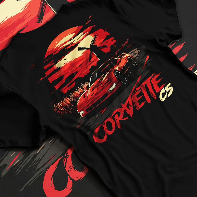 Black T-shirt featuring red Corvette C5 graphic in bold American muscle car streetwear design with sunset artwork for car culture fans.