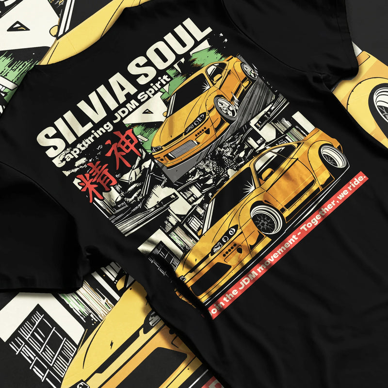Black T-shirt featuring Nissan Silvia JDM drift graphic in bold tuner streetwear design with manga-style artwork and yellow Silvia illustration.