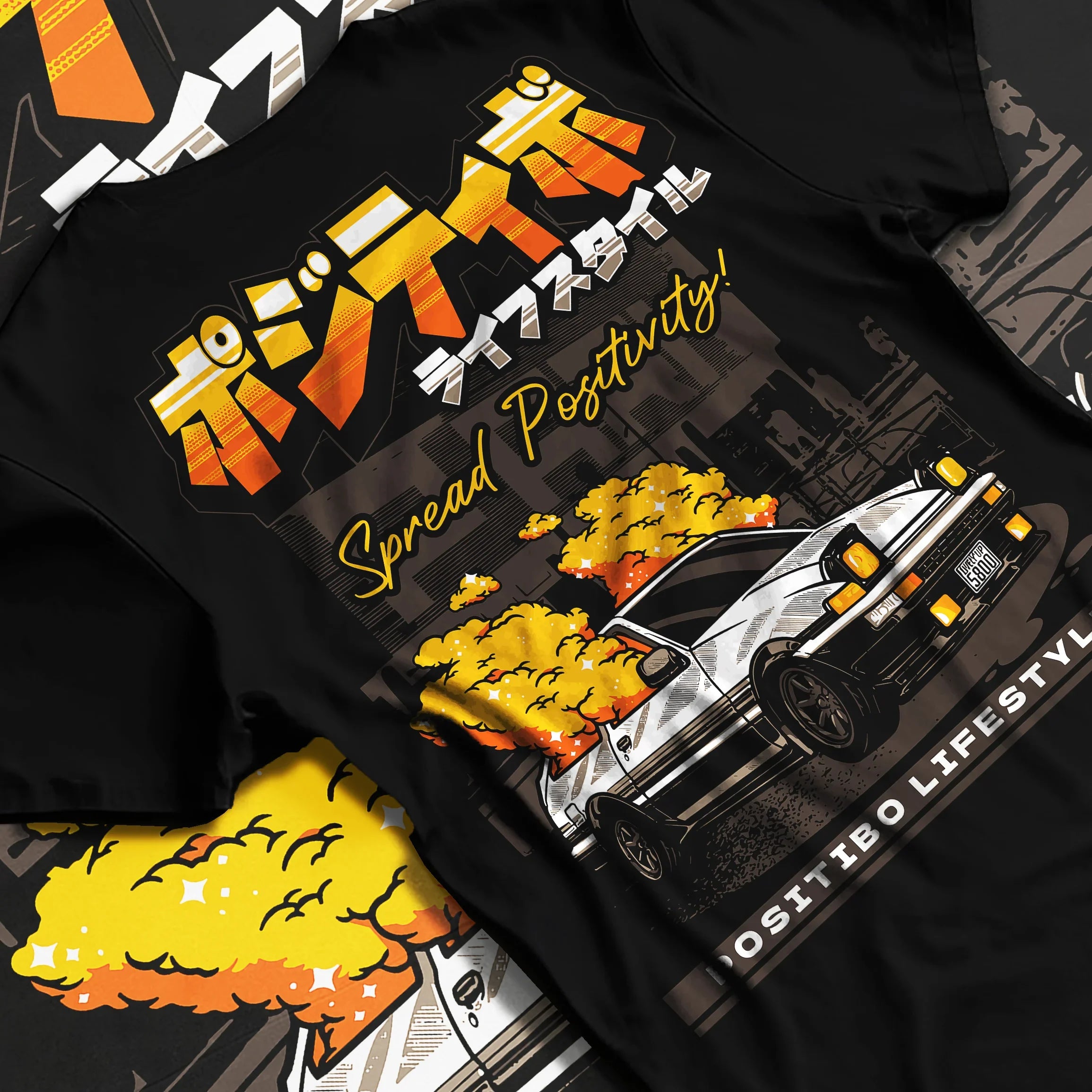 Black T-shirt featuring Toyota AE86 JDM drift graphic in bold manga-style streetwear design with yellow smoke artwork.
