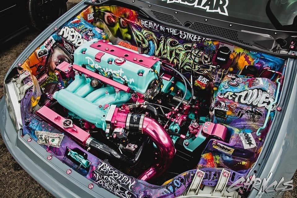 Trackhead JDM engine bay with turbo setup, carbon intakes, and high-performance tuning parts for petrolheads