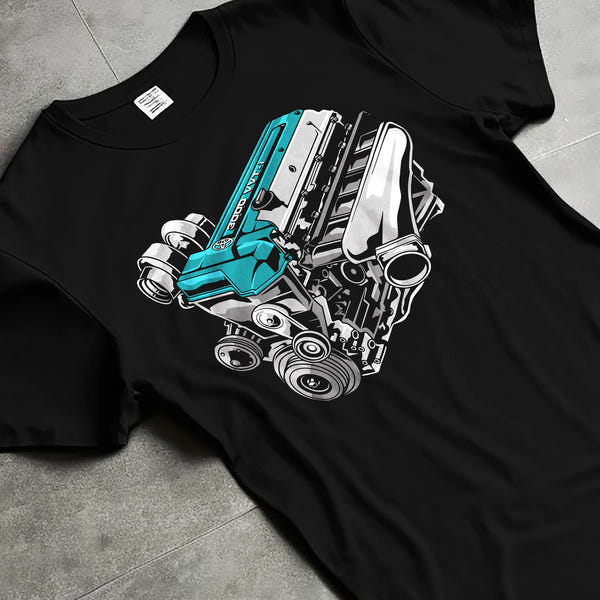 Black hoodie worn by a male model, front view, featuring Toyota Supra turbo 2jz racing jdm street power enthusiast graphic.