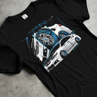 Black T-shirt laid flat with natural fabric folds, featuring ACURA jdm tuning stance slammed bagged street enthusiast graphic.