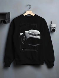 Black crewneck sweatshirt on a hanger against a grey wall, featuring Mercedes-Benz AMG rs racing motorsport street graphic.