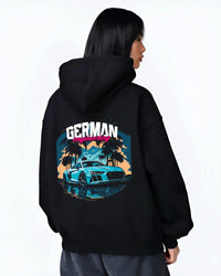 Black hoodie worn by a female model, back view, featuring Audi R8 german street racing performance motorsport automotive graphic.