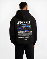 Black hoodie worn by a male model, back view, featuring Nissan Skyline R34 gt r r34 skyline racing drift jdm street graphic.