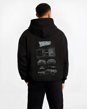 Black hoodie worn by a male model, back view, featuring DeLorean DMC-12 street retro racing performance motorsport graphic.